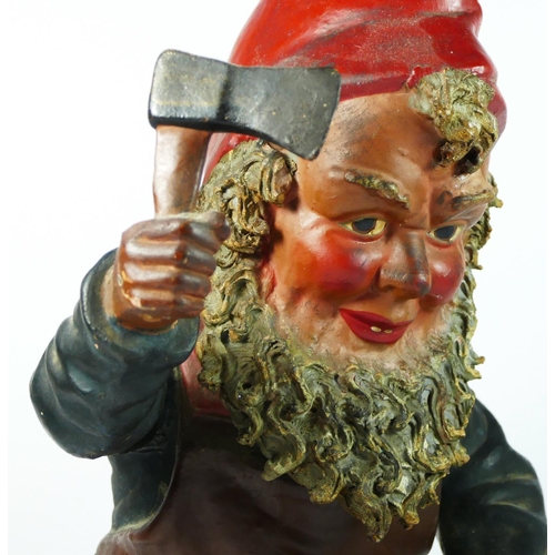 172 - A late 19th/early 20th century pottery gnome figurine, chopping wood with an axe, 46cm