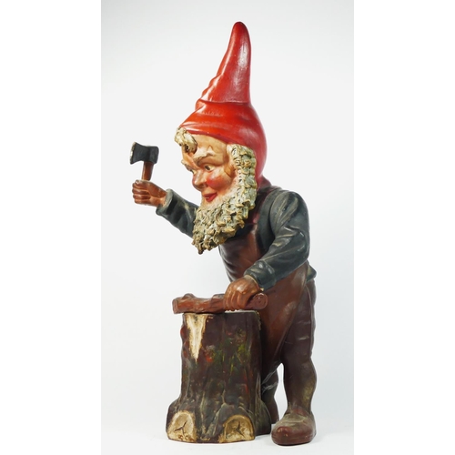 172 - A late 19th/early 20th century pottery gnome figurine, chopping wood with an axe, 46cm