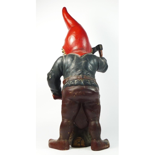 172 - A late 19th/early 20th century pottery gnome figurine, chopping wood with an axe, 46cm