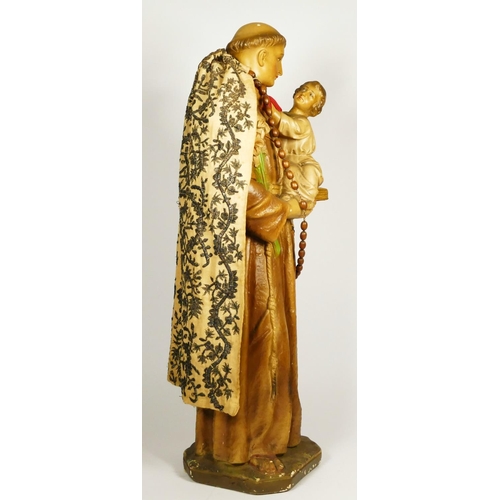 174 - An early 20th century painted plaster statue of St Antony of Padua holding the infant Jesus, 63cm.