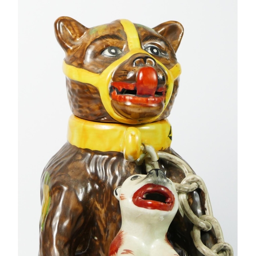 179 - A bear baiting advertising jar and cover, modelled as a large bear clutching a snarling dog between ... 