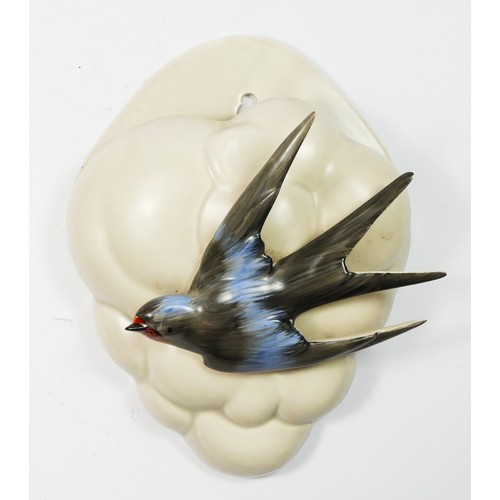 190 - Clarice Cliff pottery wall pockets, circa 1940s, one modelled as a swallow in front of a cloud, toge... 