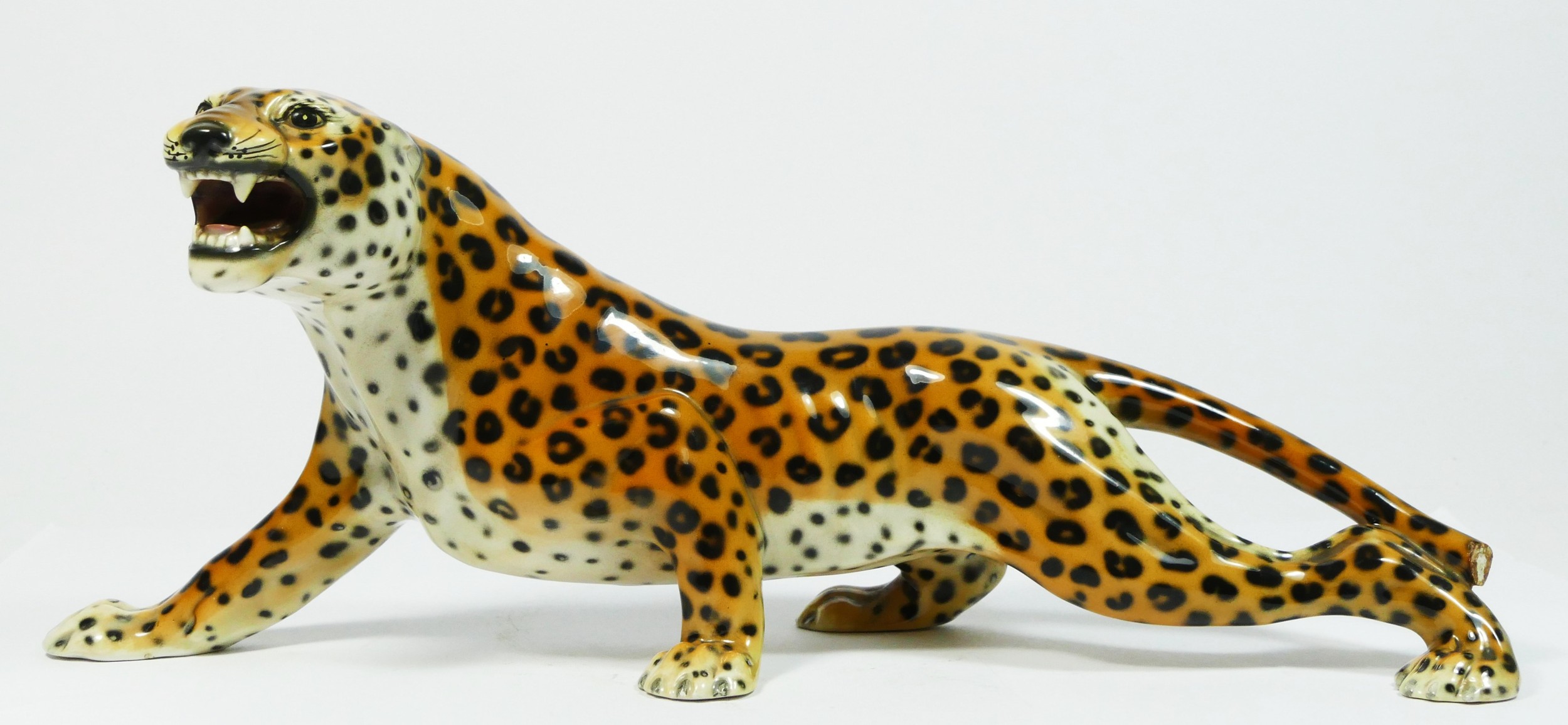 An Italian Majolica ceramic sculpture of a prowling leopard, by 