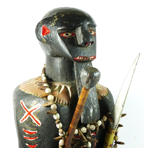 212 - A carved and painted wooden figure of a warrior, probably Ghanaian, 66cm.