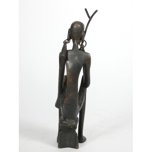 214 - An African cast bronze figure of a seated woman, 21cm,