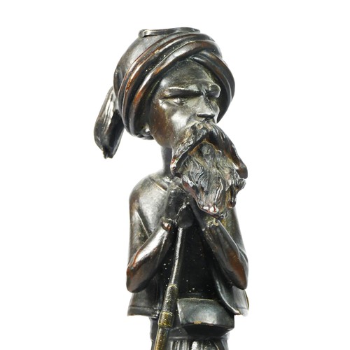 220 - A bronzed spelter figure of a Middle Eastern gunman, oak base, 35cm