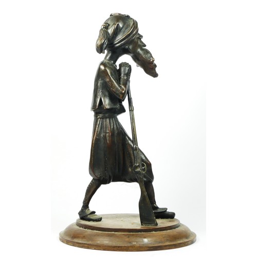 220 - A bronzed spelter figure of a Middle Eastern gunman, oak base, 35cm