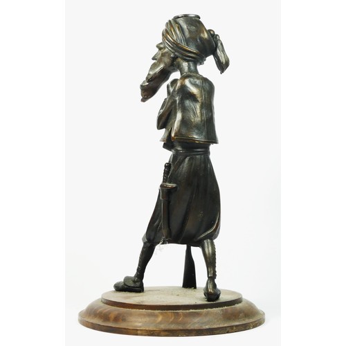 220 - A bronzed spelter figure of a Middle Eastern gunman, oak base, 35cm