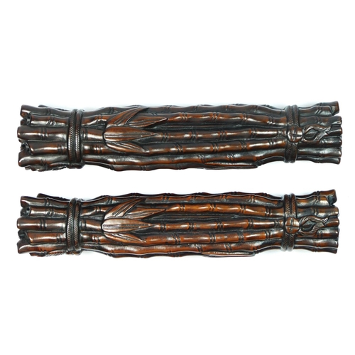 227 - A Chinese pair of hardwood scroll weights, in the form of tied bamboo rods, 24cm.