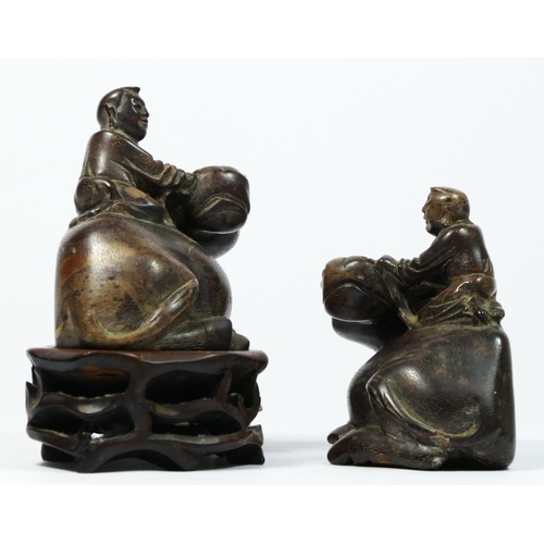 252 - A Chinese pair of carved soapstone water buffalos, with driver, 10 x 9 x 5.5cm, one on hardwood stan... 