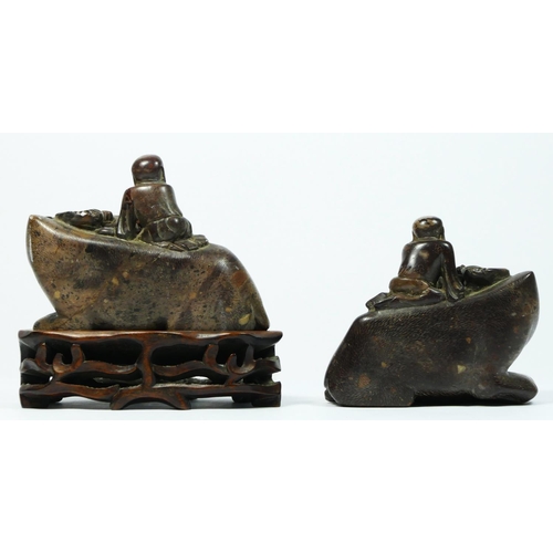 252 - A Chinese pair of carved soapstone water buffalos, with driver, 10 x 9 x 5.5cm, one on hardwood stan... 