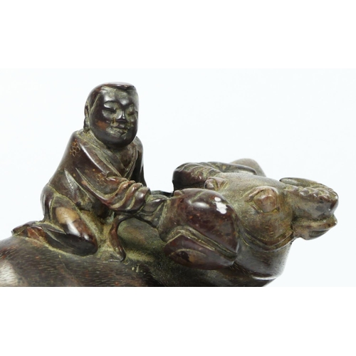 252 - A Chinese pair of carved soapstone water buffalos, with driver, 10 x 9 x 5.5cm, one on hardwood stan... 