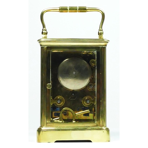 273 - An early 20th century brass striking carriage clock, white enamel dial with Roman numerals, the move... 