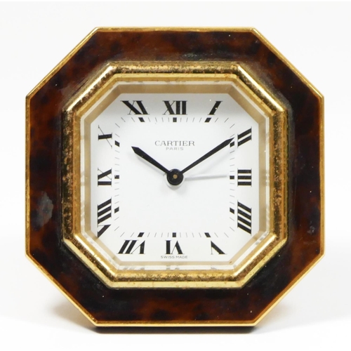 279 - An octagonal easel alarm clock by Cartier of Paris, gilded brass with faux tortoiseshell surround, s... 