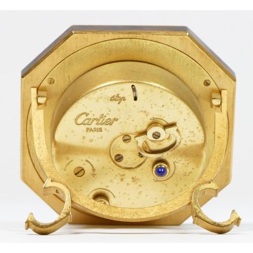 279 - An octagonal easel alarm clock by Cartier of Paris, gilded brass with faux tortoiseshell surround, s... 