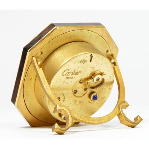 279 - An octagonal easel alarm clock by Cartier of Paris, gilded brass with faux tortoiseshell surround, s... 