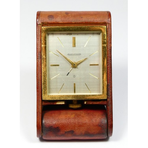 281 - Jaeger LeCoultre, a brass 8 day manual wind alarm clock in leather travel case, the brushed silver d... 