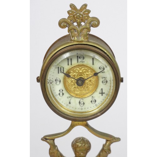 291 - The British United Clock Co. Ltd., an early 20th century brass desk time piece, in the form of a boy... 