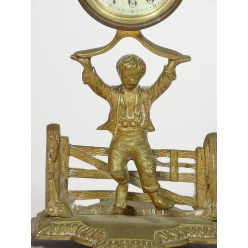 291 - The British United Clock Co. Ltd., an early 20th century brass desk time piece, in the form of a boy... 