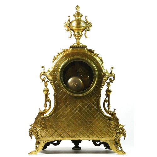 297 - A French Gilt metal ormolu striking mantel clock with garniture, late 19th century, urn shaped finia... 