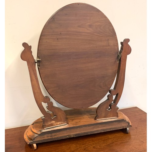 369 - A Victorian mahogany dressing table mirror, the oval plate with foliate carved cresting, held in twi... 