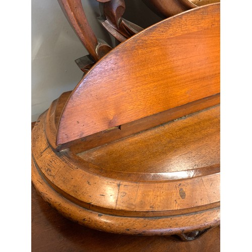 369 - A Victorian mahogany dressing table mirror, the oval plate with foliate carved cresting, held in twi... 