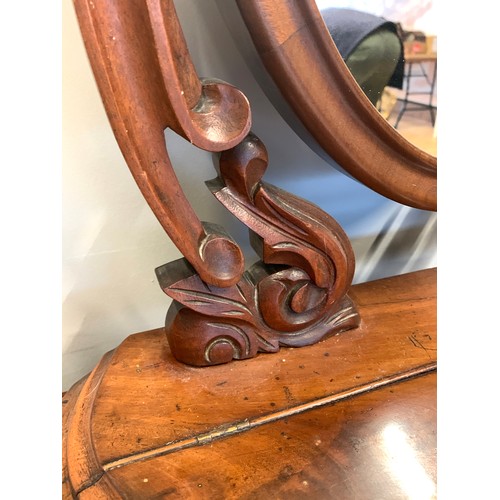 369 - A Victorian mahogany dressing table mirror, the oval plate with foliate carved cresting, held in twi... 