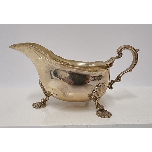 36 - An Edwardian silver gravy boat, Sheffield 1903 with shell capped cast feet - 18cm, 253 grams.