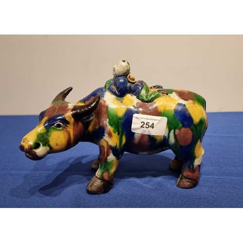 254 - A Chinese Sancai glazed figure of a water buffalo and boy, 20cm