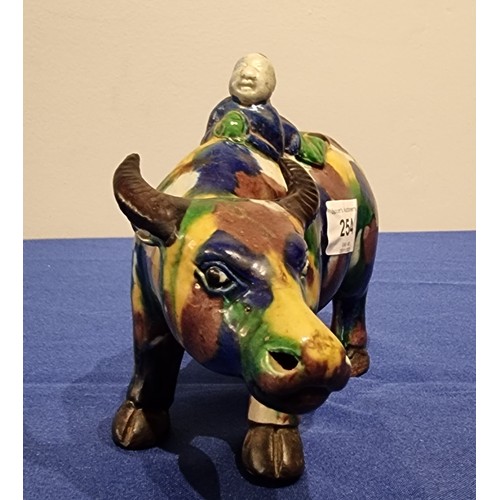 254 - A Chinese Sancai glazed figure of a water buffalo and boy, 20cm