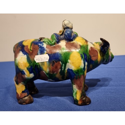 254 - A Chinese Sancai glazed figure of a water buffalo and boy, 20cm