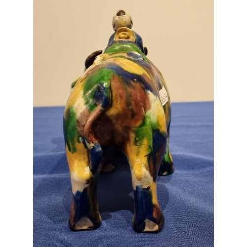 254 - A Chinese Sancai glazed figure of a water buffalo and boy, 20cm