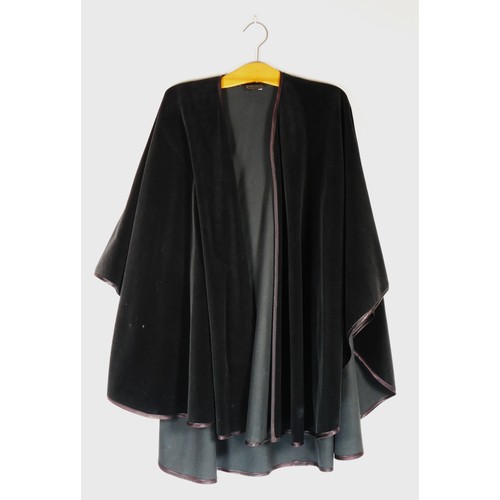 118 - A blue belted mac, quilted and lined interior, size 14, a black velvet satin trimmed cape 'volonte',... 