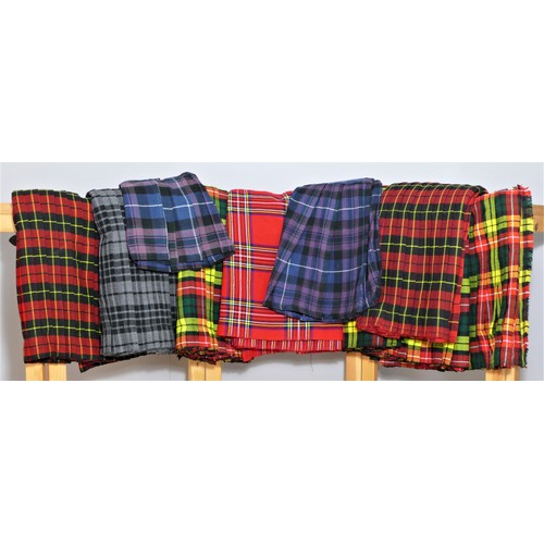 188 - Nine Scottish Highland woven tartan Kilts, unworn, various colourways, sizes 28, 30, 32 x 2, 34, 36,... 