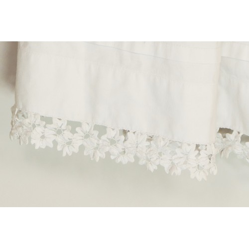 222 - Two white christening gowns, one short sleeved with lace flower detailing around chest and at hem li... 