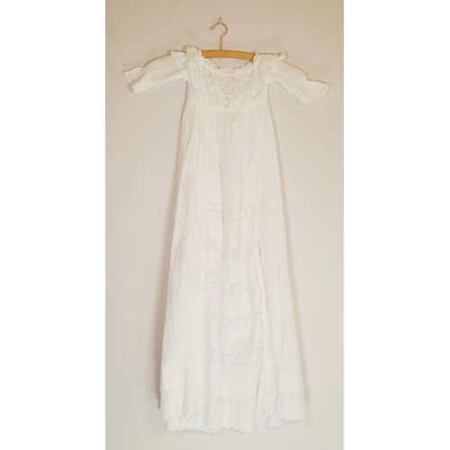 222 - Two white christening gowns, one short sleeved with lace flower detailing around chest and at hem li... 