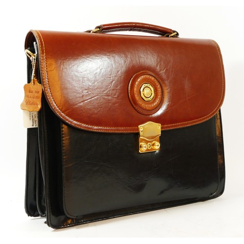 204 - A 'Marchina via Moda' black and tan brown briefcase with gold accents, logo on the front and locking... 