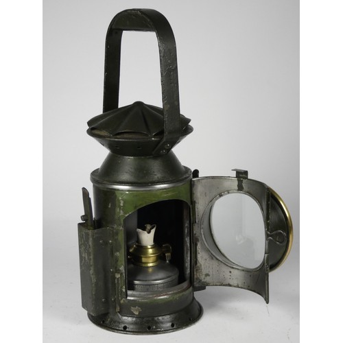 67 - A green War Dept 3 aspect handlamp, marked with W.D. broad arrow 1944, complete with burner