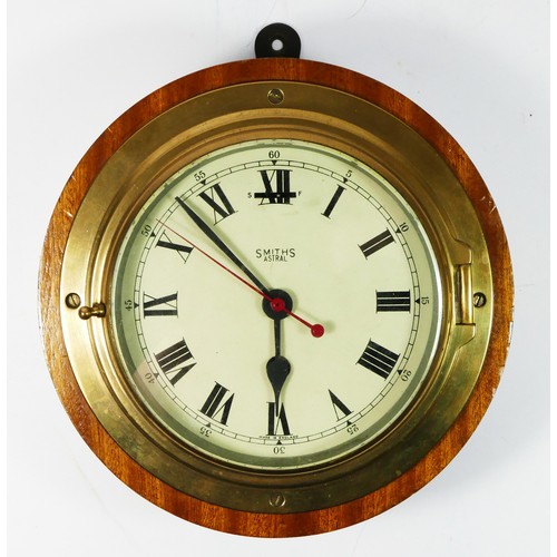 78 - A Smiths Astral bulkhead clock, with painted red second hand, 15cm diameter, mounted on a wooden bas... 