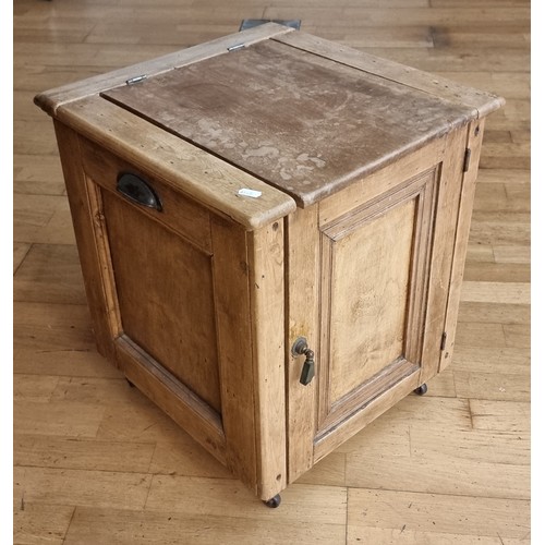 70 - A pine commode with hinged door and flap, containing a chamber pot, applied brass plague stating Do ... 