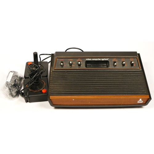 110 - An Atari 2600 “woody” (serial No 548552075), with AV and power cables, together with two joysticks

... 