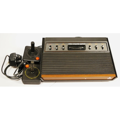 111 - An Atari 2600 “woody” (serial No 548232295), with AV and power cables, together with two joysticks

... 