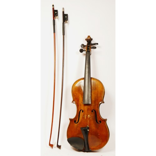 197 - A unbranded violin, with two piece back, with two later bows, one signed Czecholovakia, in a leather... 