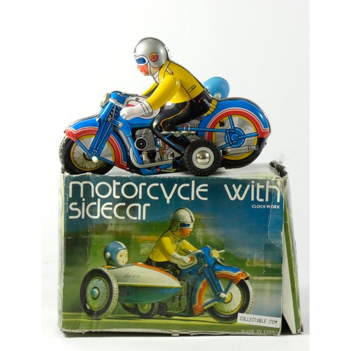 310 - A tinplate clockwork motorcycle with sidecar, made in China, original box, 18cm