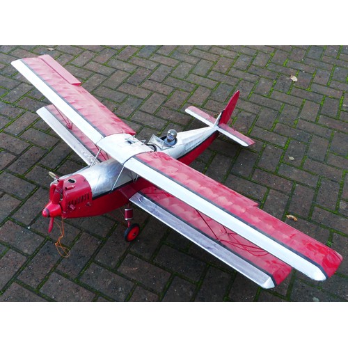 316 - A remote control model plane, dual wing, Irvine engine, red and silver livery with two figures in th... 