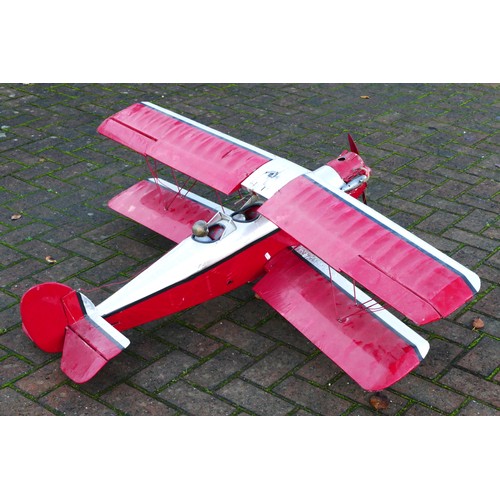 316 - A remote control model plane, dual wing, Irvine engine, red and silver livery with two figures in th... 