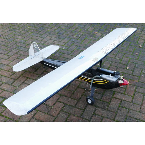 318 - A remote control model plane, unknown engine, black, gold and white livery, silver livery wings with... 