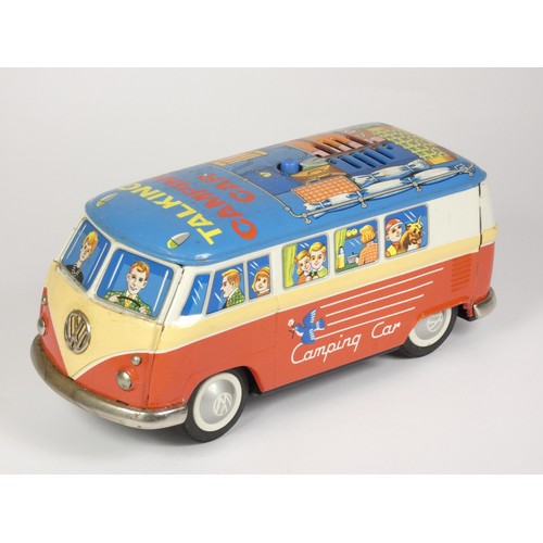 329 - A talking camping car, in the form of a VW campervan, made in Japan, together with a tinplate train,... 