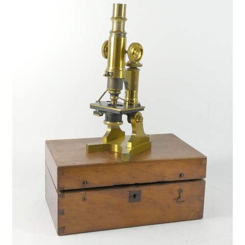 339 - A unmarked brass microscope, brass case and body, with accessories, in wooden box with fitted interi... 