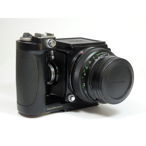 355 - A Bronica ETRS medium format camera, with 50mm f2.8 lens, manual grip and 120 film back, with manual